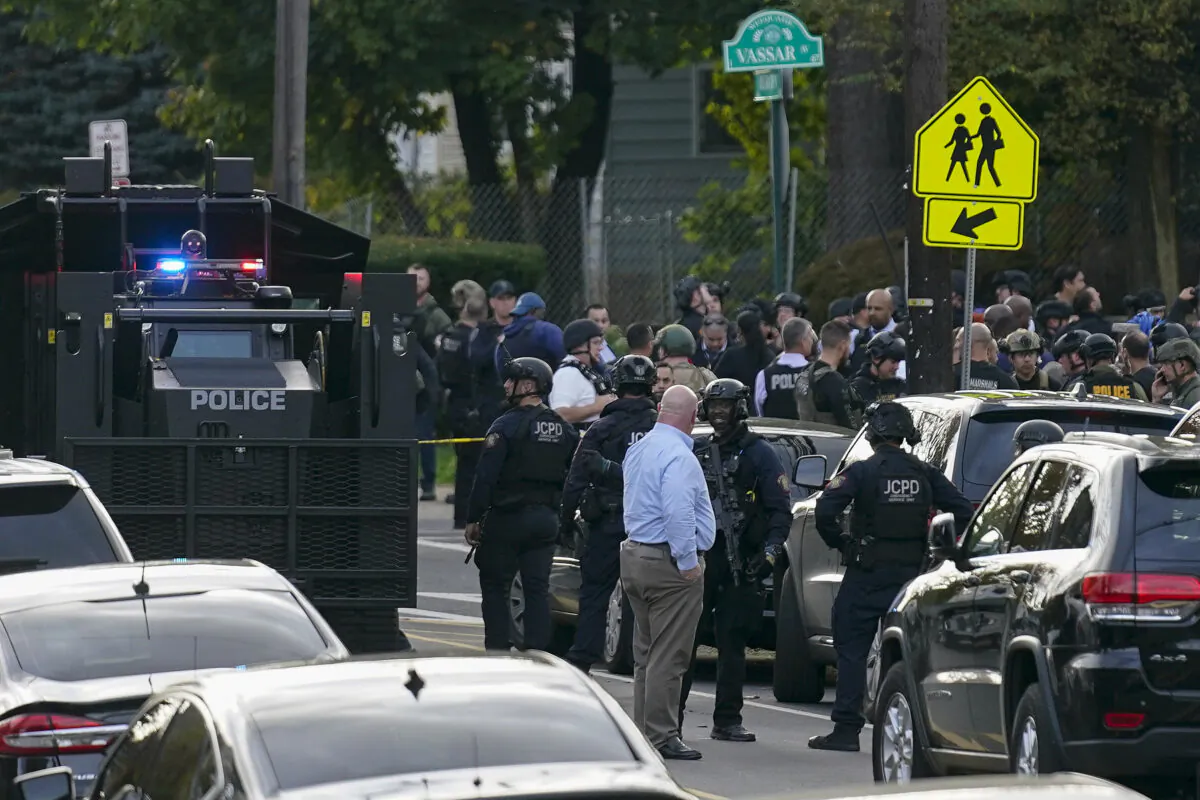 Law enforcement personnel gather at the scene where two officers were reported shot in Newark, N.J., on Nov. 1, 2022. (Seth Wenig/AP Photo)