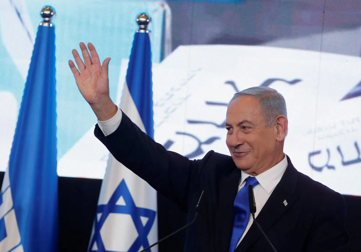 Likud party leader Benjamin Netanyahu waves as he addresses his supporters at his party headquarters during Israel's general election in Jerusalem on Nov. 2, 2022. (Ammar Awad/Reuters)