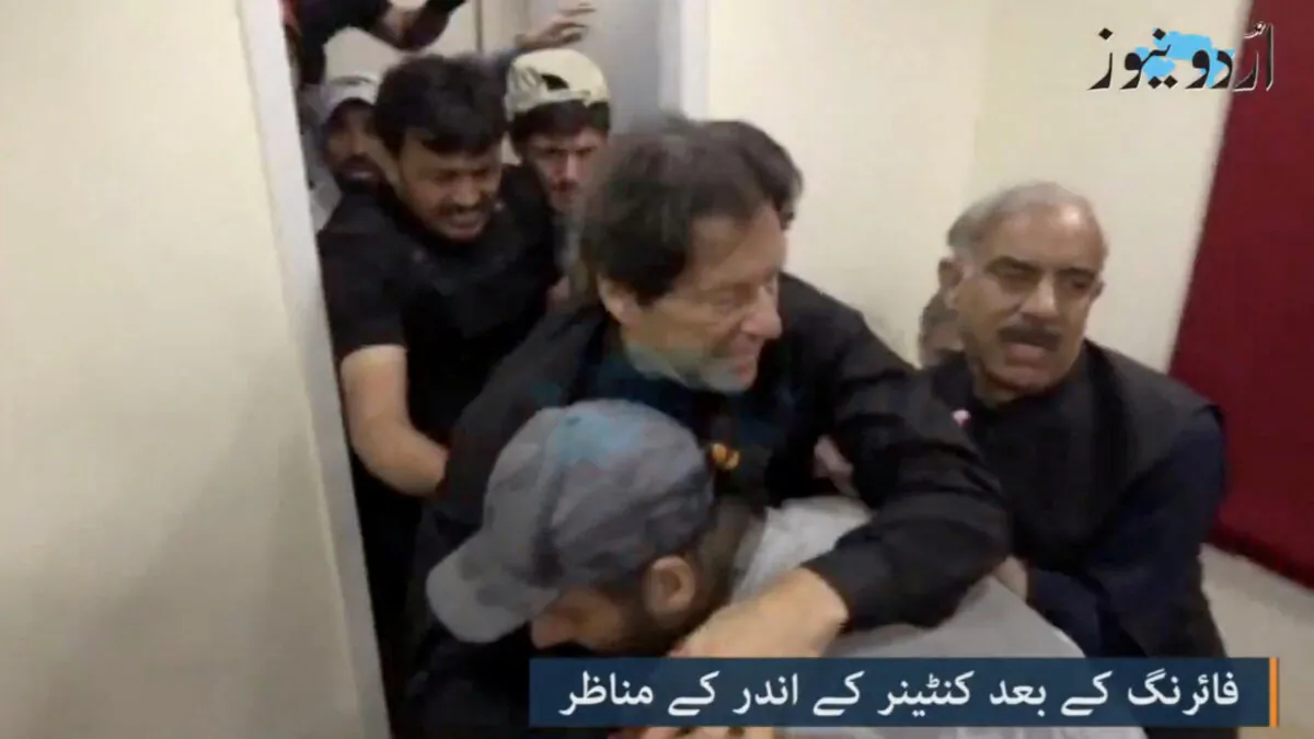 Former Pakistani Prime Minister Imran Khan is helped after he was shot in the shin in Wazirabad, Pakistan, on Nov. 3, 2022 in this still image obtained from video. (Urdu Media via Reuters)