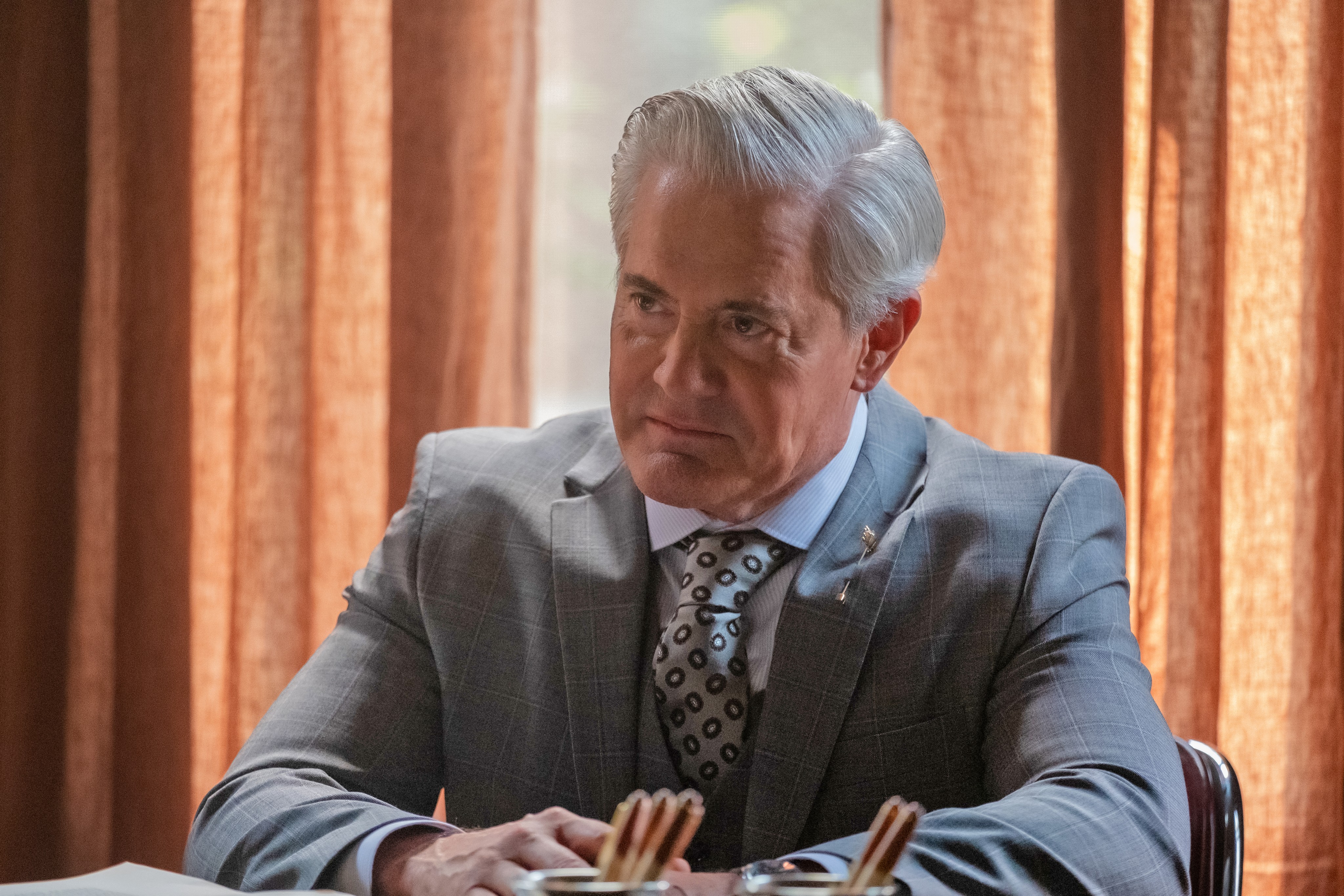 Man in grey suit in Confess, Fletch