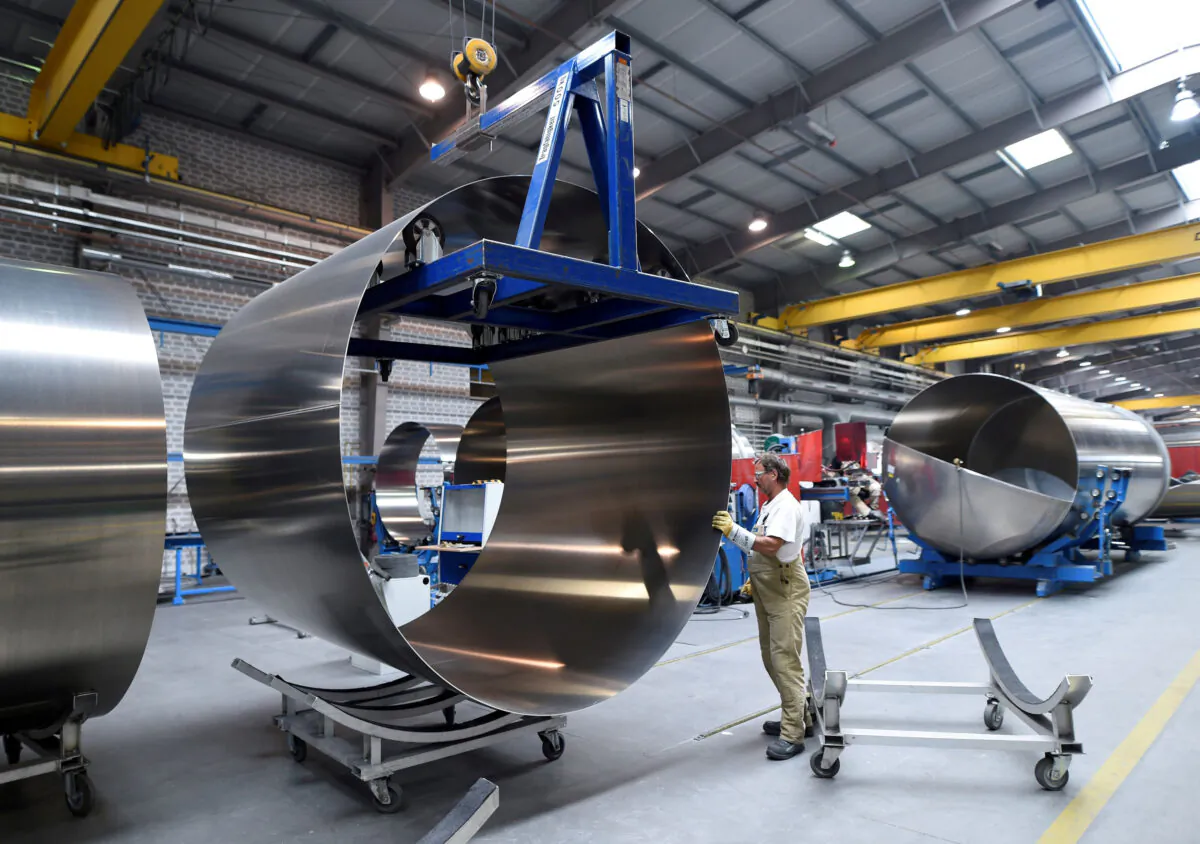A worker at German manufacturer of silos and liquid tankers, Feldbinder Special Vehicles, moves rolls of aluminium at the company's plant in Winsen, Germany, on July 10, 2018. (Fabian Bimmer/Reuters)