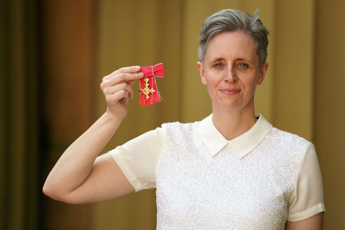 Professor of philosophy at the University of Sussex, Kathleen Stock, poses with her medal after being appointed an Officer of the Order of the British Empire (OBE) for services to higher education at an investiture ceremony at Buckingham Palace, London, on July 14, 2022. (Victoria Jones/POOL/AFP via Getty Images)