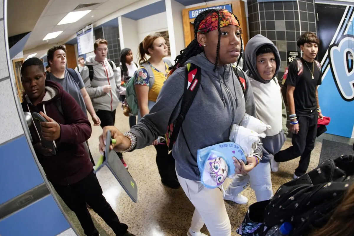 Students at Washington Junior High School use the unlocking mechanism to open the bags in which their cellphones were sealed during the school day, in Washington, Pa., on Oct. 27, 2022. (Keith Srakocic/AP Photo)