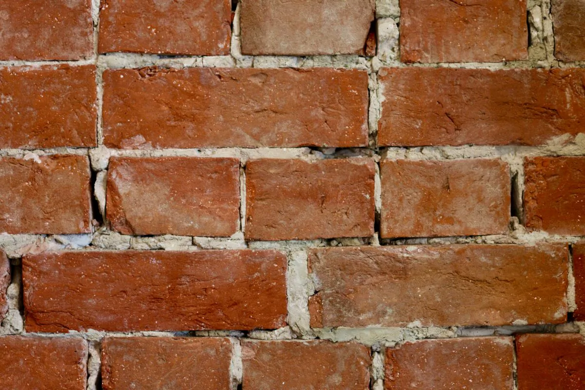 Replacing crumbling mortar in between stones, concrete blocks, or brick is something you can do.
(James Orr/Unsplash)