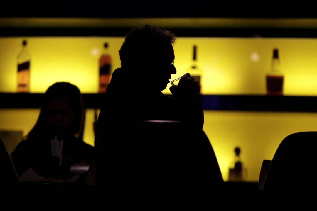 A patron sips his drink while having a meal at a bar in New Jersey on Nov. 30, 2017. (Julio Cortez/AP Photo)