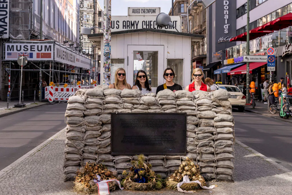 Tourists take a photo at Checkpoint Charlie, the best-known Berlin Wall crossing point between East Berlin and West Berlin during the Cold War, on July 3, 2021 in Berlin, Germany. (Courtesy of Maja Hitij/Getty Images)