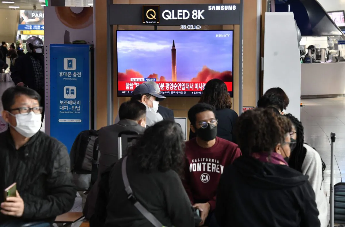 People watch a television screen showing a news broadcast with file footage of a North Korean missile test, at a railway station in Seoul, South Korea, on Nov. 3, 2022. (Jung Yeon-je/AFP via Getty Images)