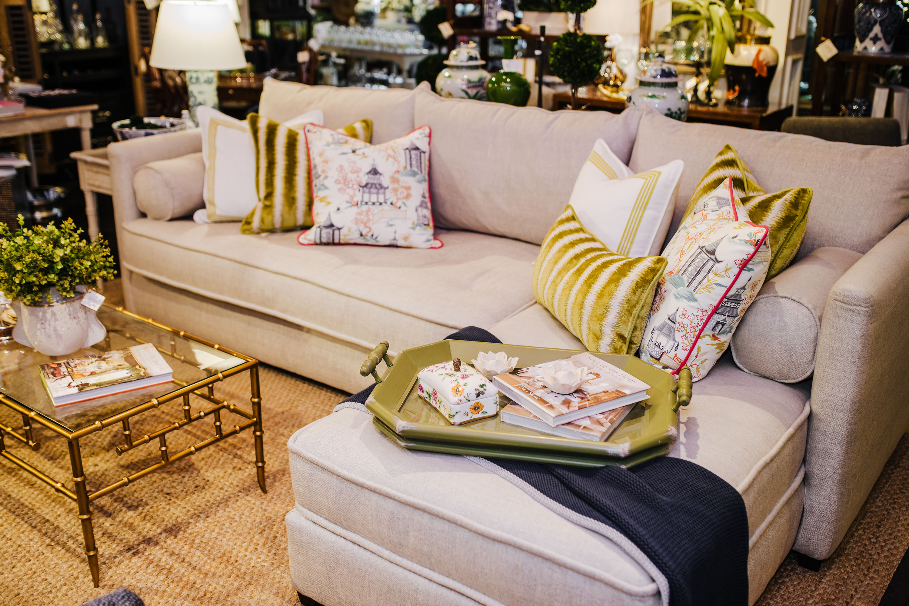 A neutral sofa is dressed up with cheery colorful fabrics.