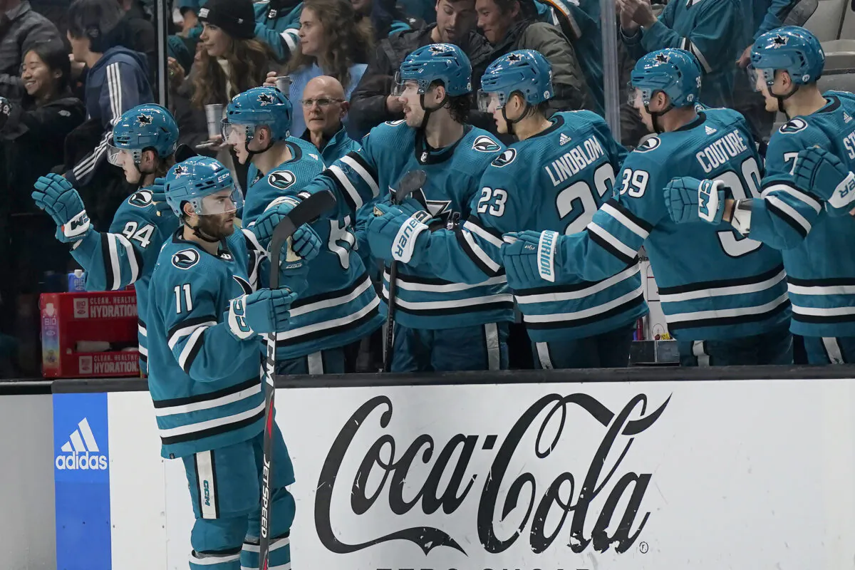 San Jose Sharks center Luke Kunin (11) is congratulated for his goal against the Anaheim Ducks during the second period of an NHL hockey game in San Jose, Calif., on Nov. 5, 2022. (Jeff Chiu/AP Photo)