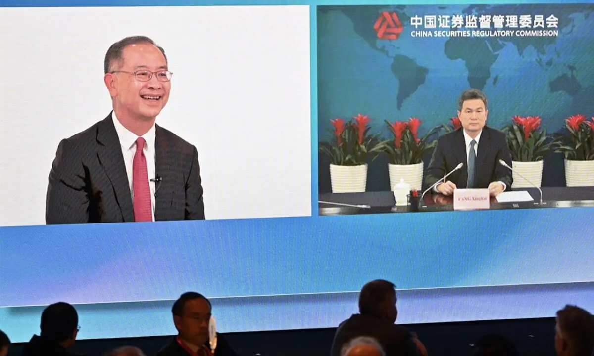 Chief Executive of the Hong Kong Monetary Authority (HKMA), Eddie Yue Wai-man (Left), speaks to Fang Xinghai, vice chairman of China Securities Regulatory Commission (Right), via video link at the opening of the Global Financial Leaders Investment Summit in Hong Kong on Nov. 2, 2022. At the summit of global bankers, Fang Xinghai told investors they should avoid reading international press coverage of China's economy, comments that received endorsement from two senior executives. (Peter PARKS/AFP)