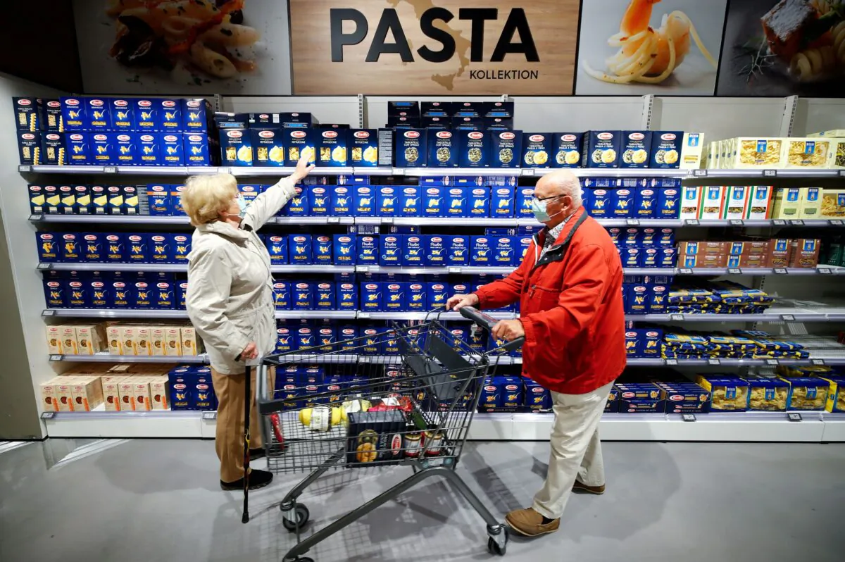 Customers at the Edeka grocery store buy pasta in Duesseldorf, Germany, on April 29, 2020. (Wolfgang Rattay/Reuters)