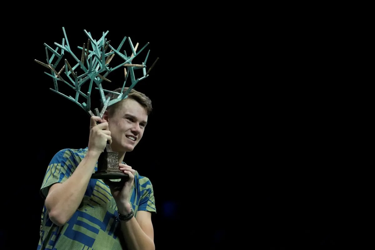 Denmark's Holger Rune celebrates with this trophy after defeating Serbia's Novak Djokovic in their Paris Masters final at the Accor Arena in Paris on Nov. 6, 2022. (Thibault Camus/AP Photo)