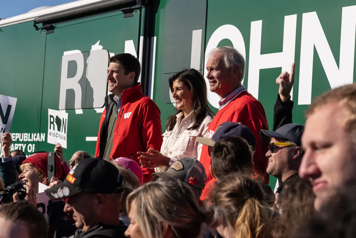 Former South Carolina Governor and U.S. Ambassador to the United Nations Nikki Haley stumps for Republican Sen. Ron Johnson (at right) in Janesville, Wis., on Nov. 7, 2022. At left is U.S. Rep. Bryan Steil, R-Wis. (Joseph M. Hanneman/The Epoch Times)