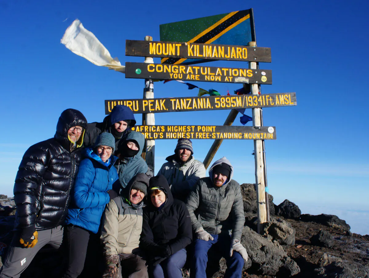 Members of the Ballard and Thomas families gather for a group photo at the top of Africa's Mount Kilimanjaro on June 29, 2022. (Courtesy of Colleen Thomas/TNS)