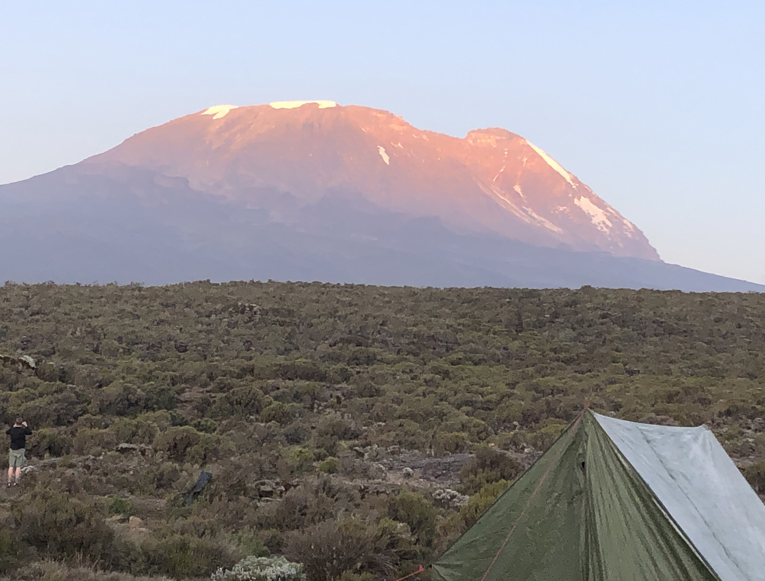 Mount Kilimanjaro can be seen in the distance from Shira I Camp on day three of the climb.