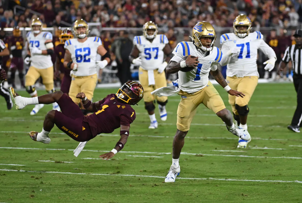 Dorian Thompson-Robinson (1) of the UCLA Bruins runs with the ball while breaking a tackle by Jordan Clark (1) of the Arizona State Sun Devils during the second quarter at Sun Devil Stadium in Tempe, Ariz., on Nov. 5, 2022. (Norm Hall/Getty Images)