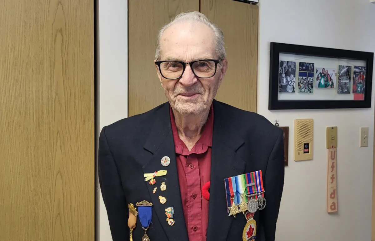 World War II Royal Canadian Navy veteran Osborne Lakness, wearing his military medals, at his home in Regina on Nov. 7, 2022. (Lee Harding/The Epoch Times)