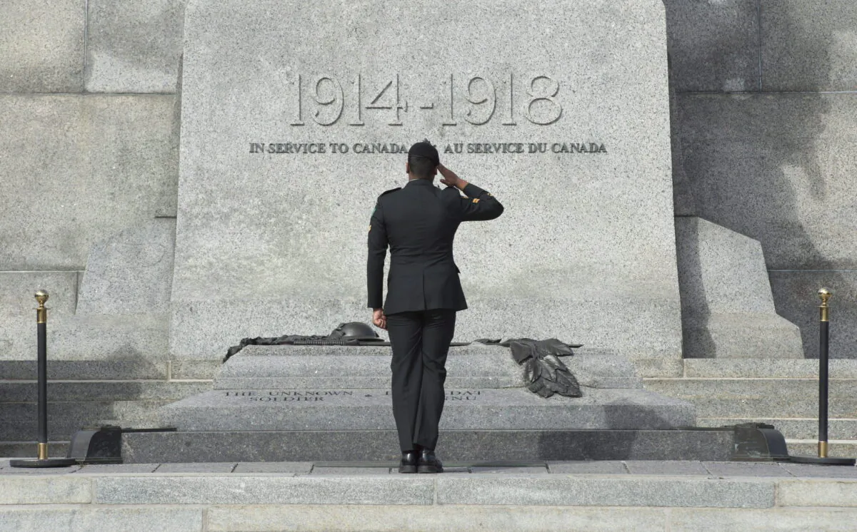 A member of the Canadian Forces salutes as he passes in front of the Tomb of the Unknown Soldier at the National War Memorial in Ottawa on Oct. 22, 2015. (The Canadian Press/Adrian Wyld)