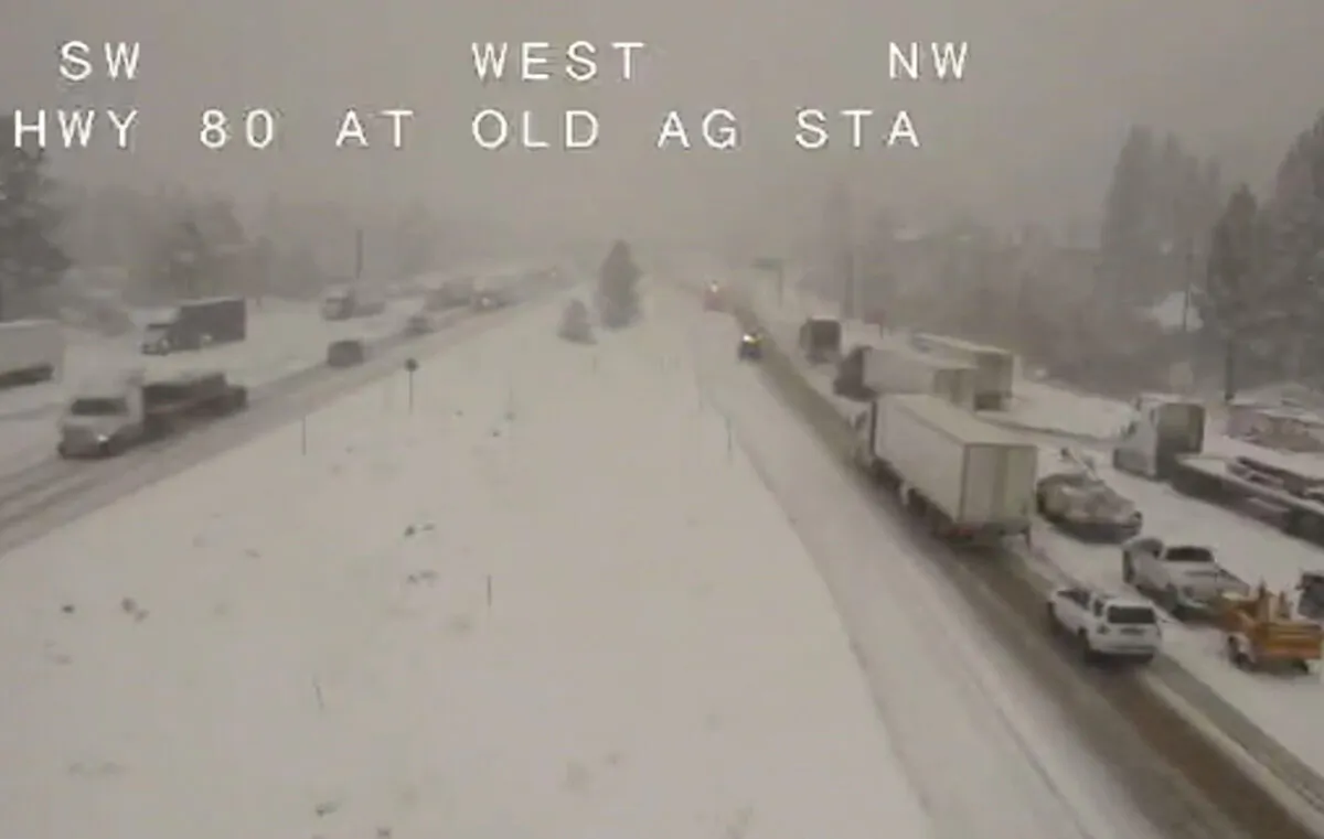 Traffic moves slowly through the snowy conditions along Interstate 80 near Truckee, Calif., on Nov. 8, 2022, in this image taken from video from a Caltrans remote video traffic camera. (Caltrans via AP)