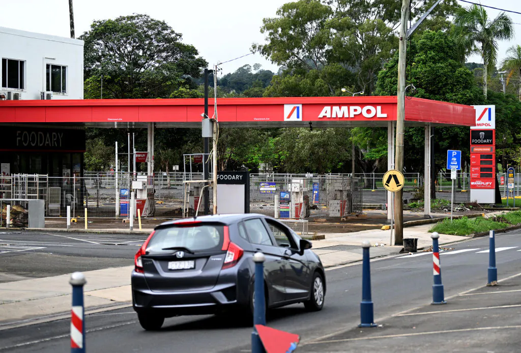 A car drives past a flood-damaged service station  in Lismore, Australia, on May 15, 2022. (Photo by Dan Peled/Getty Images)