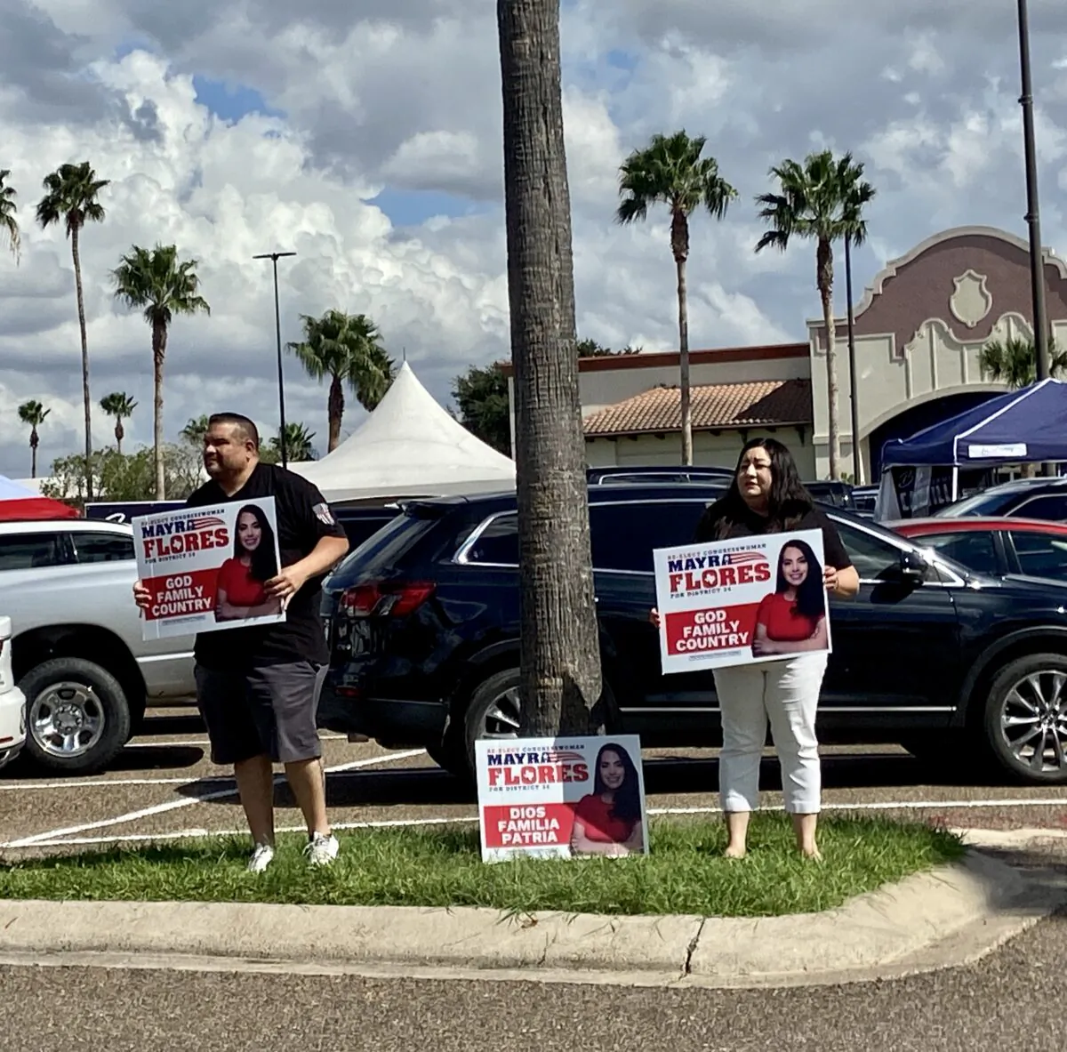 Supporters for Republican Mayra Flores hold signs outside a polling place in Weslaco, Texas. (Darlene McCormick Sanchez/The Epoch Times)
