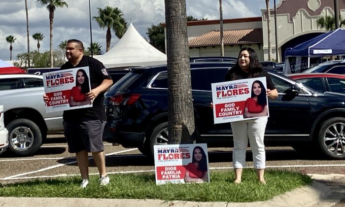 Supporters for Republican Mayra Flores hold signs outside a polling place in Weslaco, Texas. (Darlene McCormick Sanchez/The Epoch Times)
