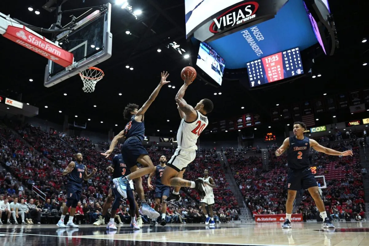 San Diego State Aztecs guard Matt Bradley (20) shoots the ball over Cal State Fullerton Titans guard Tory San Antonio (23) during the first half at Viejas Arena in San Diego, on Nov 7, 2022. (Orlando Ramirez-USA TODAY Sports via Field Level Media)