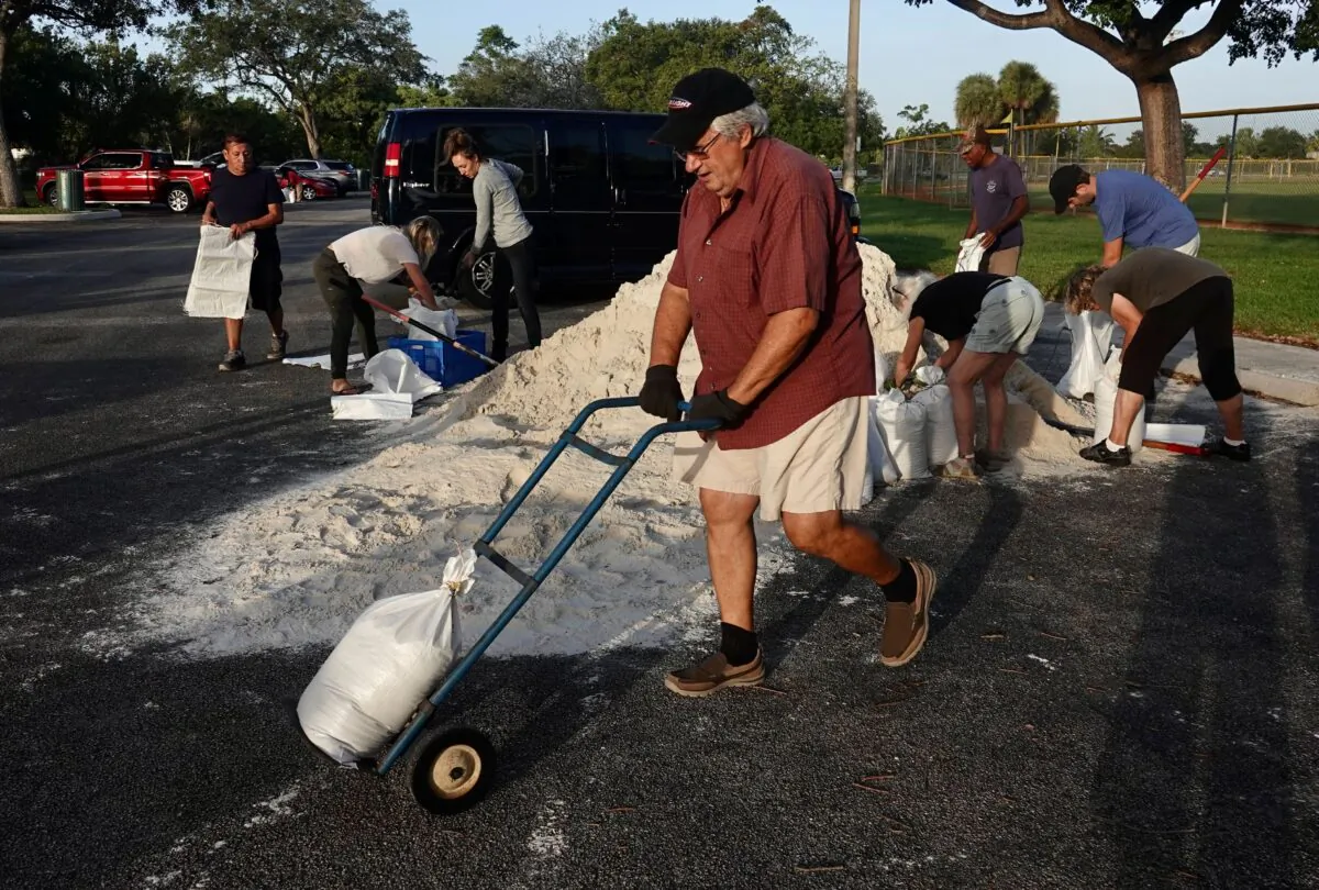 Sandbags are distributed at Mills Pond Park in Fort Lauderdale, Fla., on Nov. 8, 2022, ahead of Subtropical Storm Nicole. (Joe Cavaretta/South Florida Sun-Sentinel via AP)