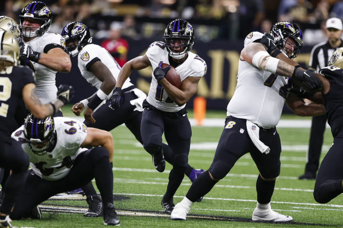 Baltimore Ravens running back Kenyan Drake, center, runs with the ball in the first half of an NFL football game against the New Orleans Saints in New Orleans, on Nov. 7, 2022. (Butch Dill/AP Photo)