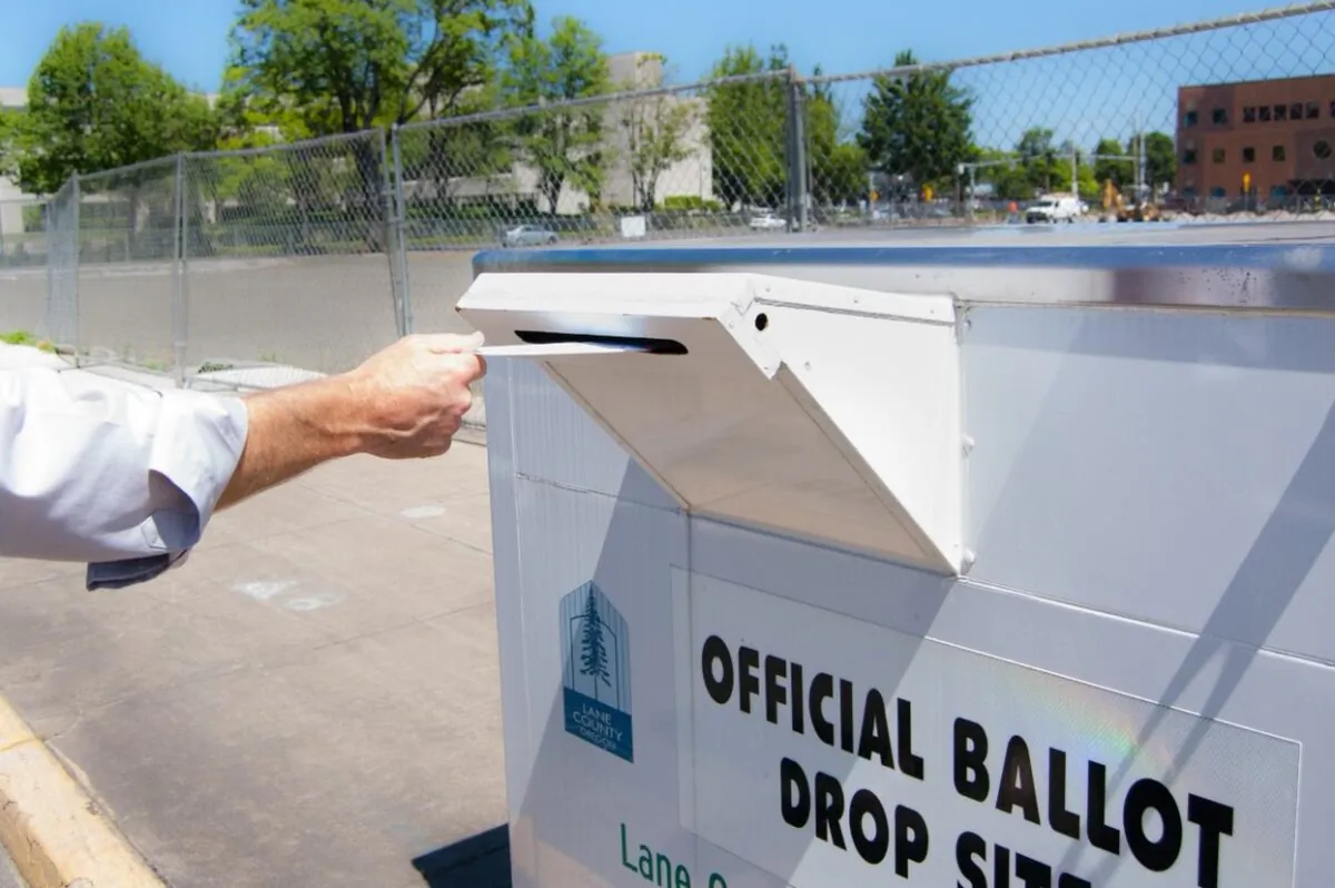 An Oregon voter drops an absentee ballot in Lane County. (Courtesy of Lane County Elections)