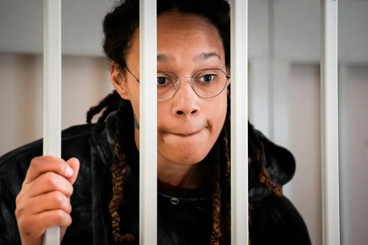 WNBA star and two-time Olympic gold medalist Brittney Griner speaks to her lawyers standing in a cage at a court room prior to a hearing, in Khimki just outside Moscow on July 26, 2022. (Alexander Zemlianichenko, Pool/AP Photo)