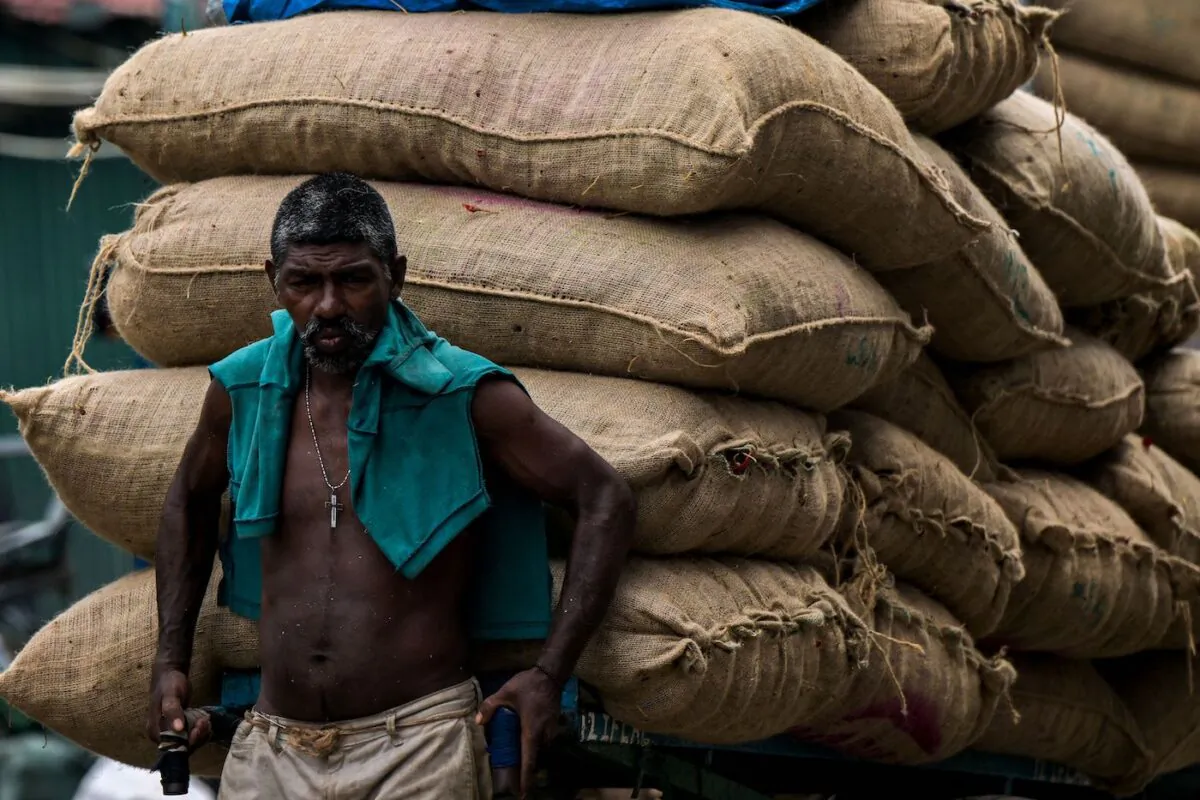A laborer pulls a cart loaded with sacks of vegetables at a market in Colombo, Sri Lanka on Oct. 21, 2022. (Ishara S. Kodikara/AFP via Getty Images)