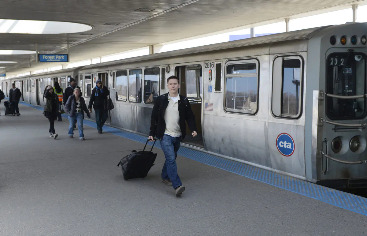 Travelers and commuters arrive at the Chicago Transit Authority's Rosemont station in Chicago on March 24, 2014. (Brian Kersey/Getty Images)