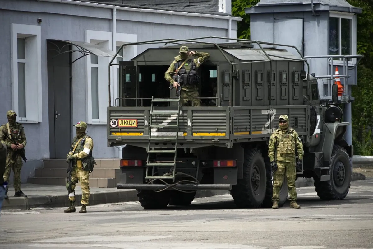 Russian soldiers guard an area as a group of foreign journalists visit Kherson, south Ukraine, on May 20, 2022. (AP Photo)