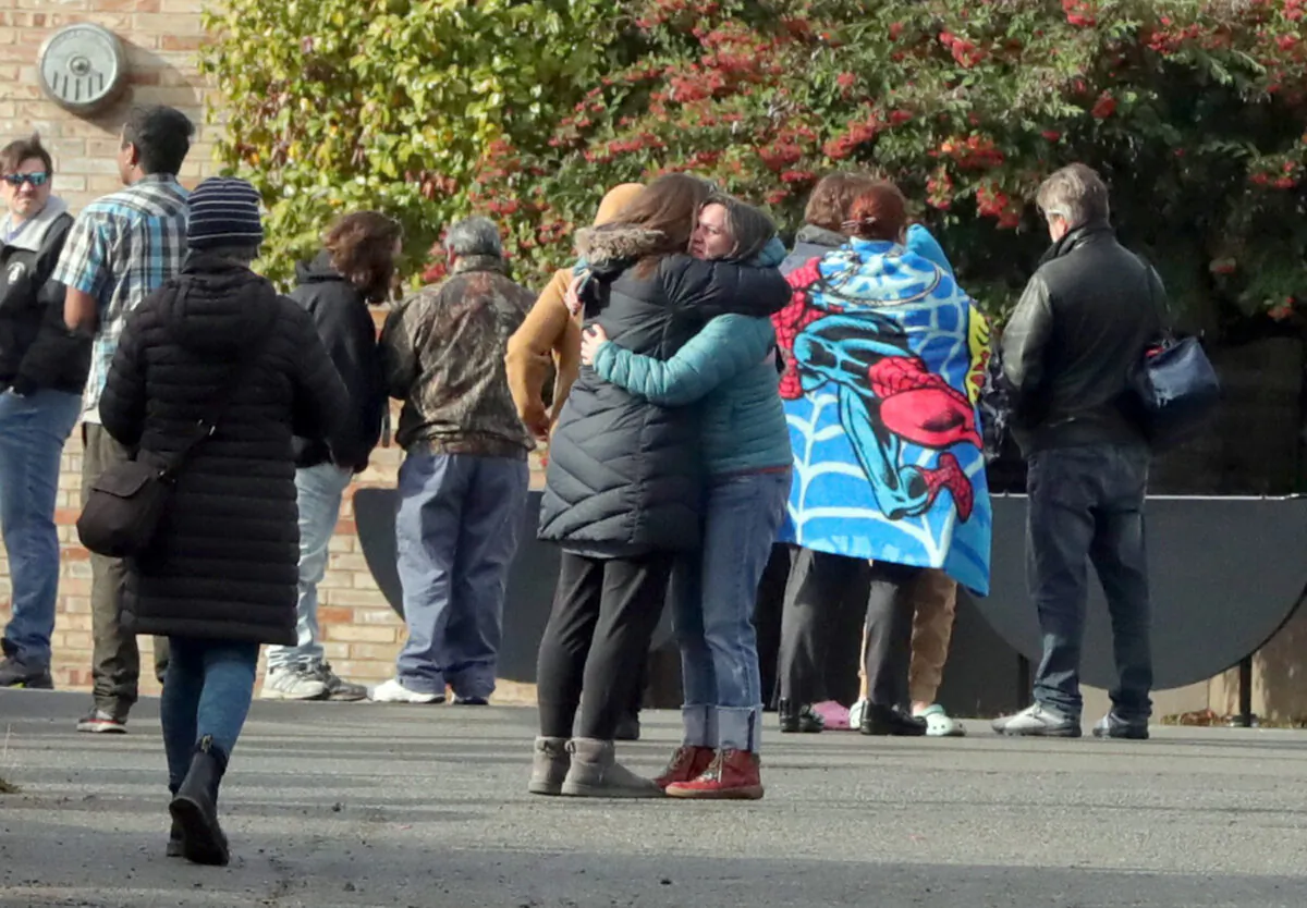 Parents comfort each other outside of Ingraham High School after reports of a school shooting in Seattle on Nov. 8, 2022. (Greg Gilbert/The Seattle Times via AP)
