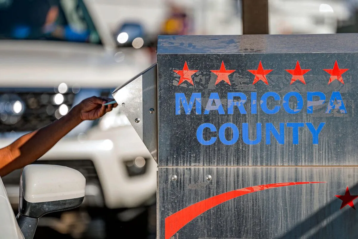 Voters drop their ballot in a dropbox in the U.S. midterm election at the Maricopa County Tabulation and Election Center, in Phoenix, Arizona on Nov. 8, 2022. (Olivier Touron/AFP via Getty Images)