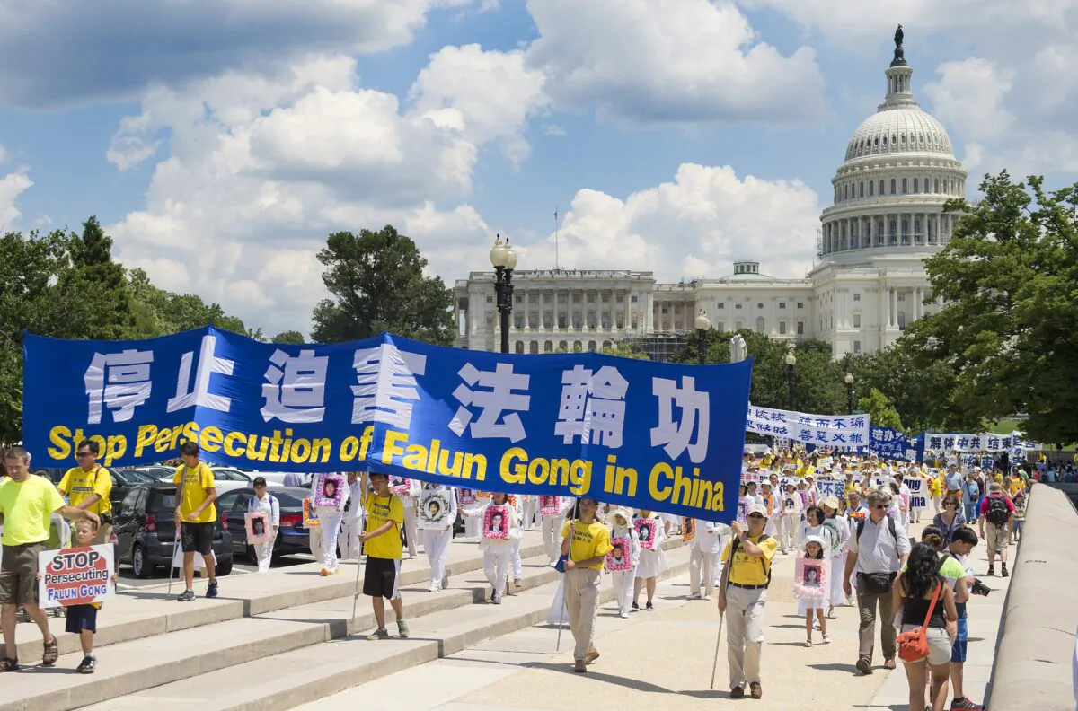 Falun Gong demonstrators march on Capitol Hill in Washington, D.C., on July 17, 2014, as part of the events sponsored by the Falun Dafa Association to end the Chinese persecution of Falun Gong practitioners. (Jim Watson/AFP via Getty Images)