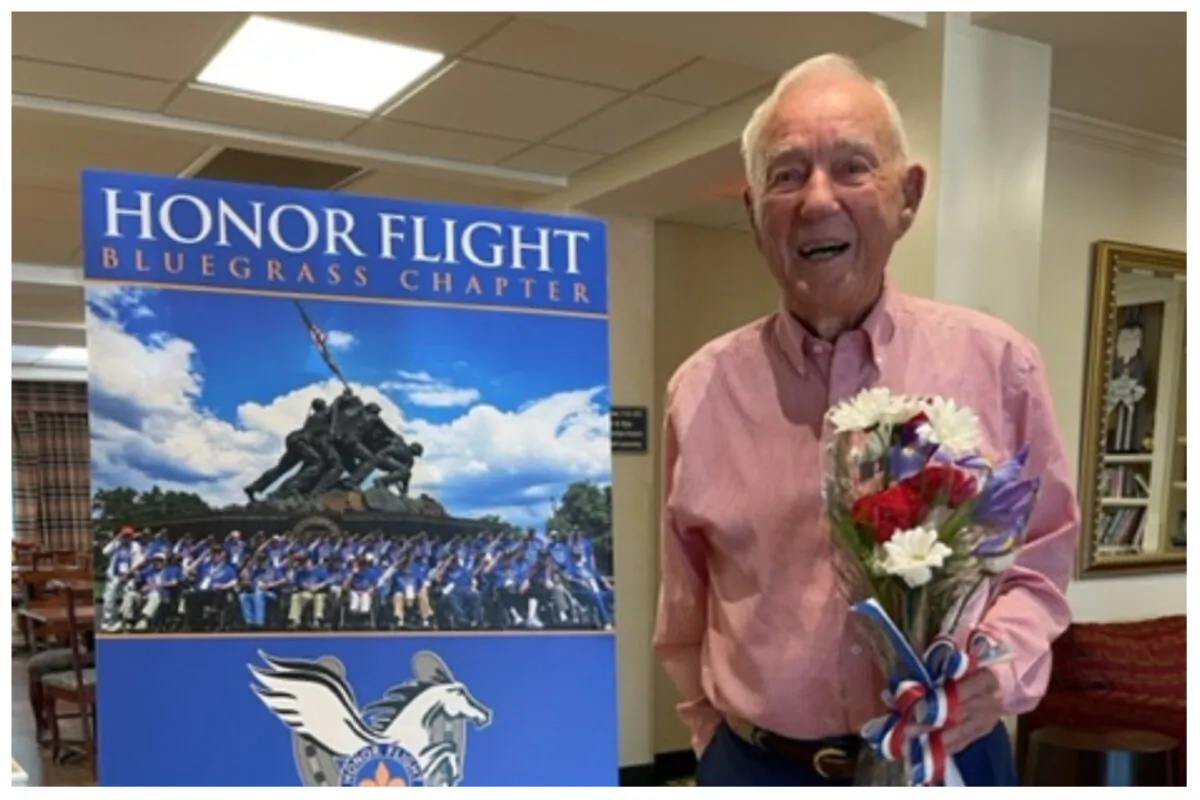 Lee Robertson was presented with a red, white, and blue bouquet of flowers at the “Welcome Home Celebration” from friends in Barren County, where he began his teaching career in 1950. (Courtesy of Bluegrass Honor Flight)