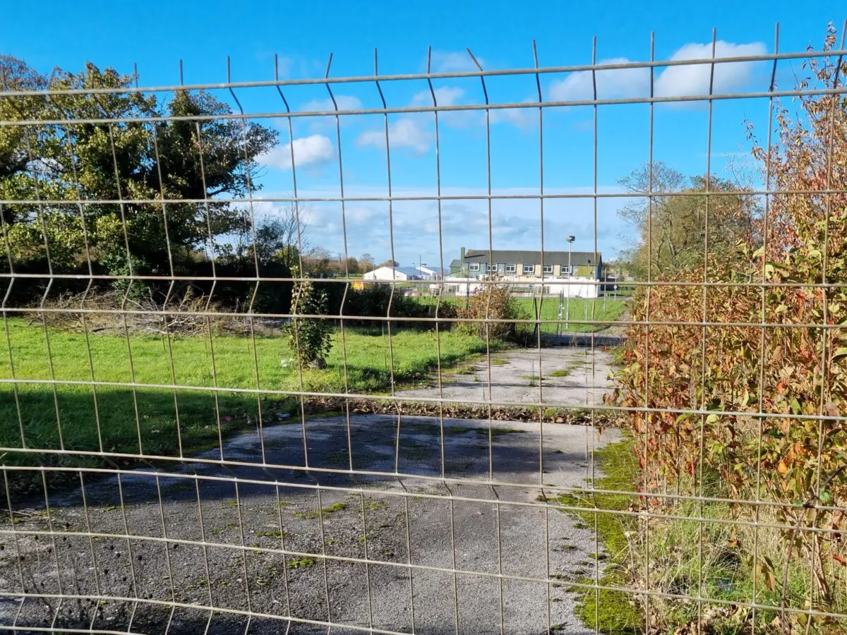 Accommodation buildings, seen through a barrier, at the illegal immigrant processing centre in Manston, Kent, England, on Nov. 9, 2022. (Chris Summers/The Epoch Times)