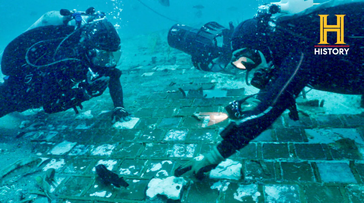 Underwater explorer and marine biologist Mike Barnette and wreck diver Jimmy Gadomski explore a twenty-foot segment of the 1986 Space Shuttle Challenger, the team discovered in the waters off the coast of Fla., in this handout picture taken on May 2022. (The History Channel/Handout via Reuters)