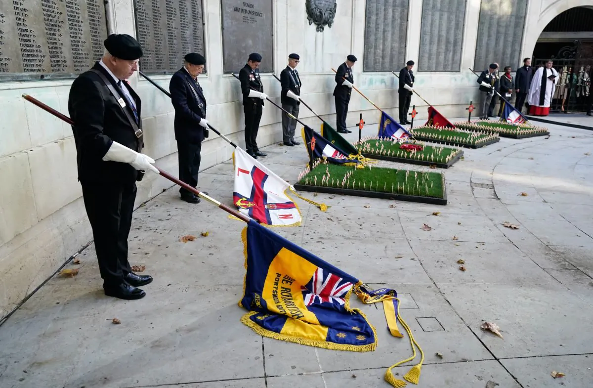 Standard bearers mark a two minutes' silence at Guildhall Square in Portsmouth on Nov. 11, 2022 (PA)