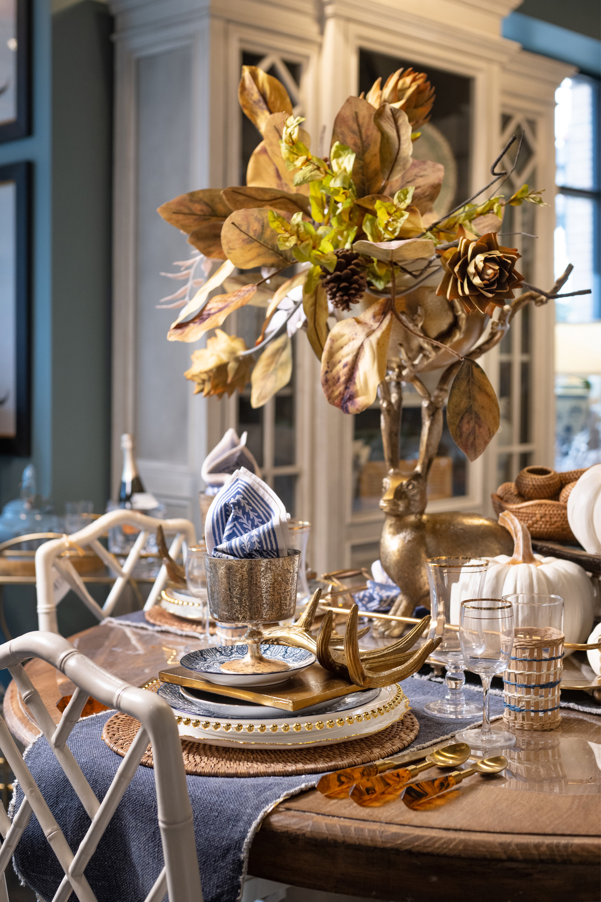 Gold is the theme of this tablescape, from the floral centerpiece to the dish details.