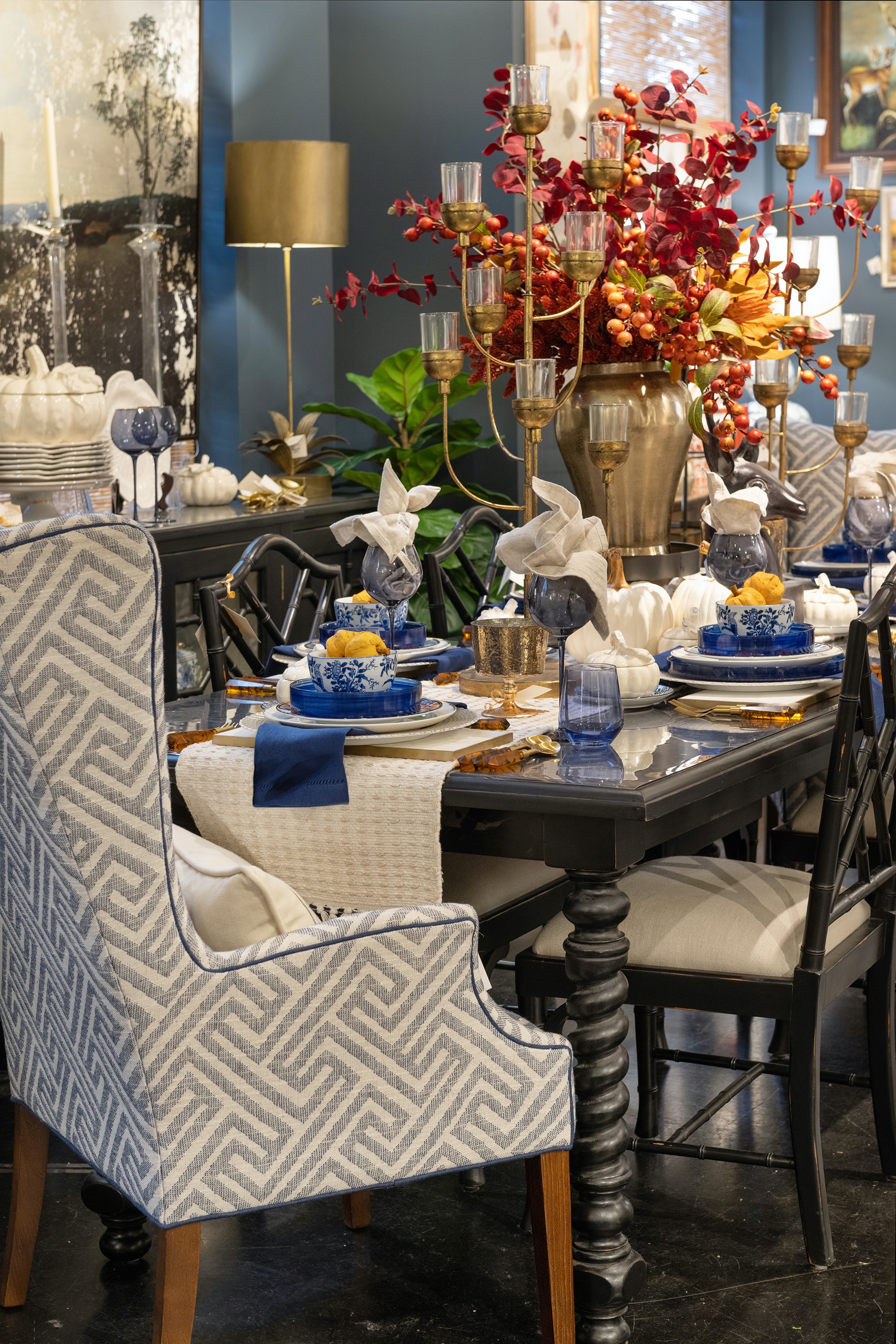 An autumnal tabletop highlights the bright colors of the foliage of the season and pairs with classic blue and white for a timeless look.