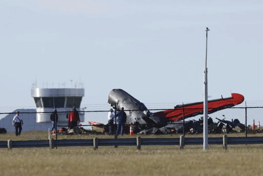 A damaged plane sits at the Dallas Executive Airport in Dallas after two historic military planes collided and crashed on Nov. 12, 2022. (Liesbeth Powers/The Dallas Morning News via AP)