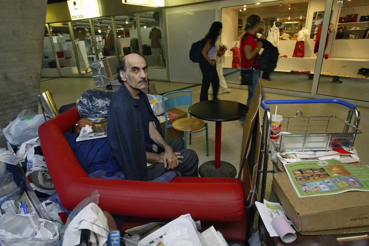 Merhan Karimi Nasseri sits among his belongings at Terminal 1 of Roissy Charles De Gaulle Airport, north of Paris, on Aug. 11, 2004. (Michel Euler/AP Photo)