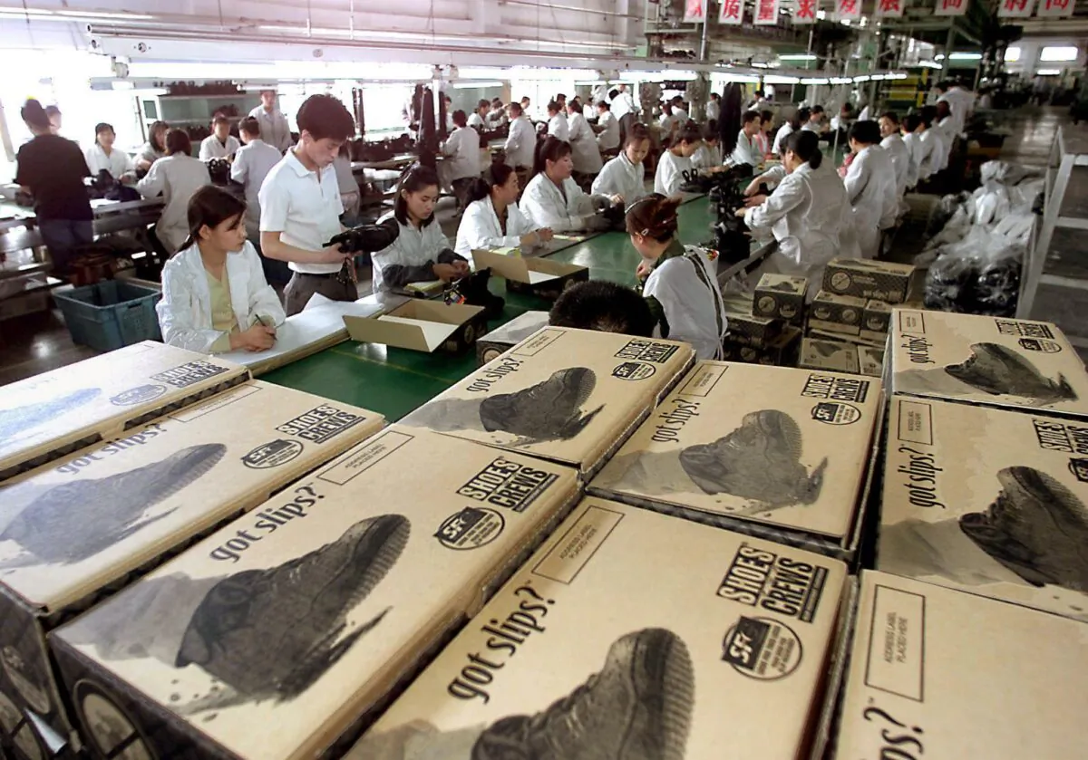 Workers at a Chinese state-owned factory in Shenyang, Liaoning Province, on May 31, 2000, produce shoes for a U.S. company. (Goh Chai Hin/AFP via Getty Images)