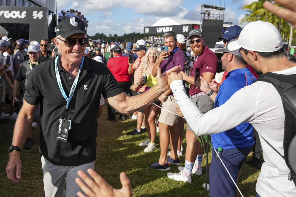 Greg Norman, CEO and commissioner of LIV Golf, shakes hands with fans during the team championship stroke-play round of the LIV Golf Invitational—Miami at Trump National Doral Miami in Doral, Fla., on Oct. 30, 2022. (Eric Espada/Getty Images)