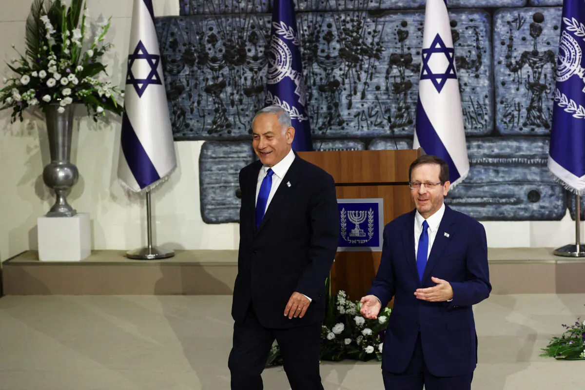 Israel's President Isaac Herzog walks next to Benjamin Netanyahu (L) during a ceremony where Herzog hands Netanyahu the mandate to form a new government following the victory of the former premier's right-wing alliance in this month's election at the President's residency in Jerusalem on Nov. 13, 2022. (Ronen Zvulun/Reuters)