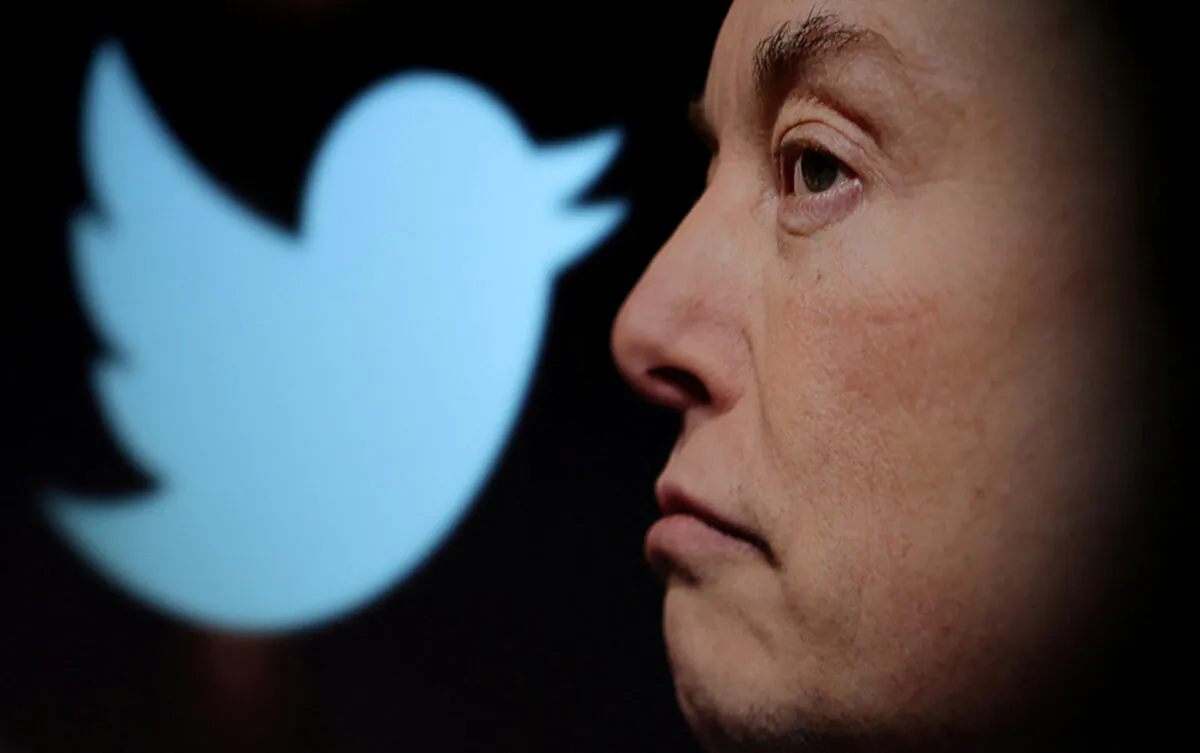 The Twitter logo and a photo of Elon Musk are displayed through a magnifier in this illustration taken on Oct. 27, 2022. (Dado Ruvic/Reuters)