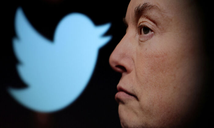 Twitter logo and a photo of Elon Musk are displayed through a magnifier in this illustration taken on Oct. 27, 2022. (Dado Ruvic/Reuters)